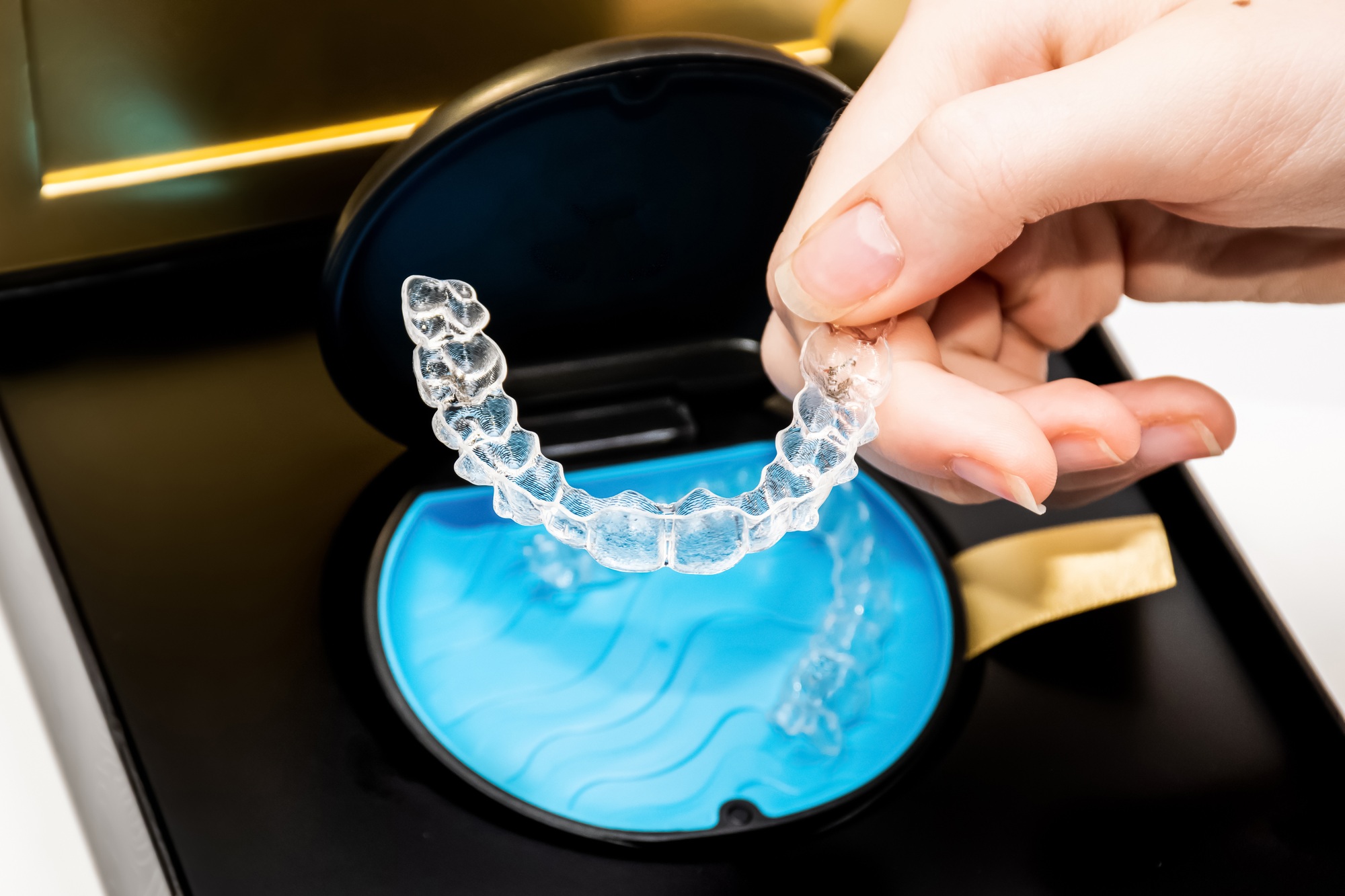 Transparent aligners in a box. Invisible braces. Clear teeth straighteners.